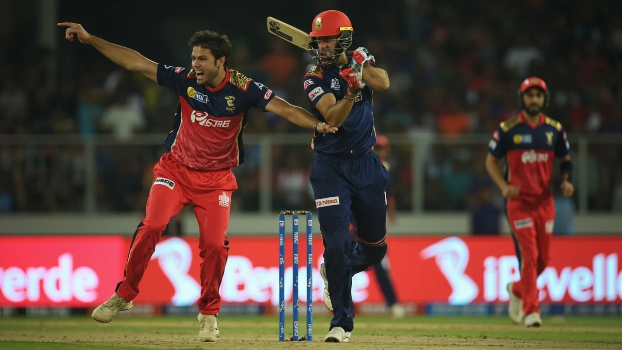 Tight sideline frame of an IPL match in mid-action, with a batter holding shape at the crease, the bowler completing his follow-through and the ball captured just past the popping crease under evening floodlights