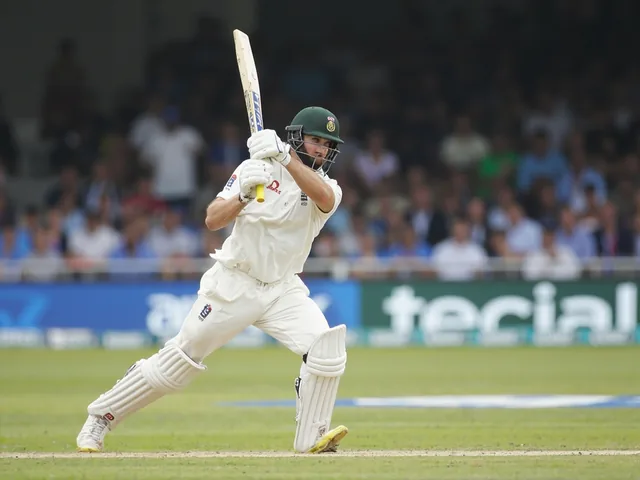Cricket batsman in batting stance with whites uniform